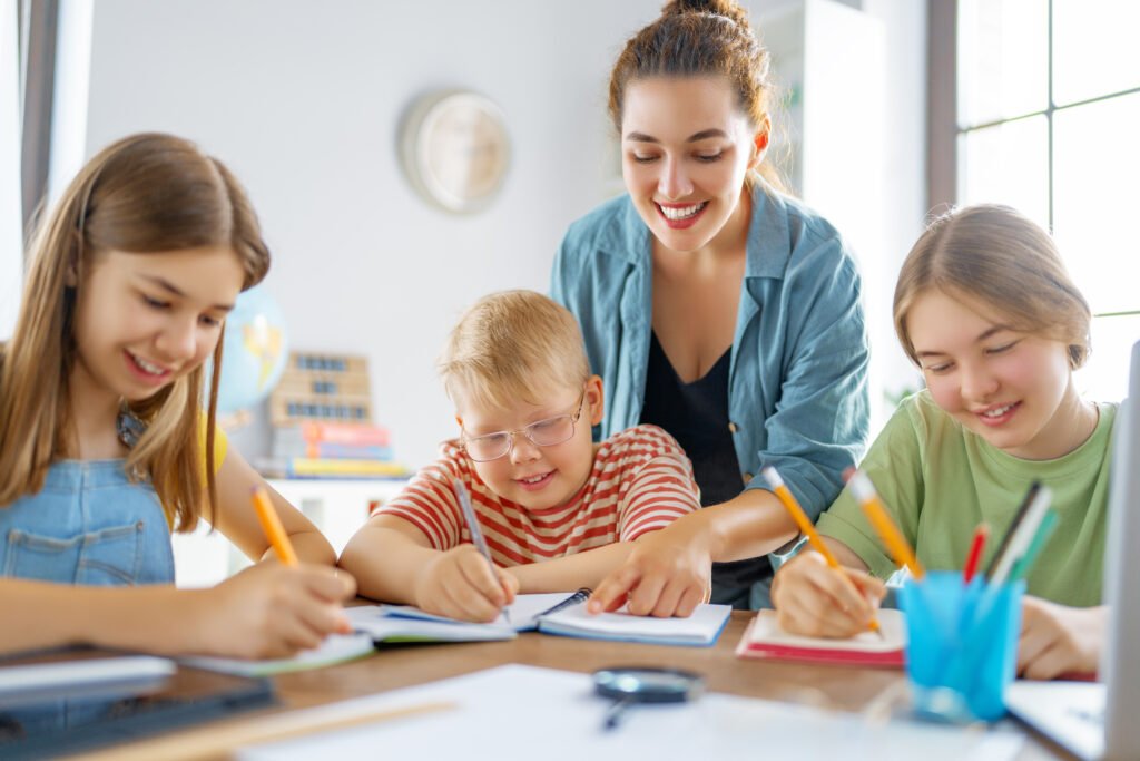 Happy kids and teacher at school